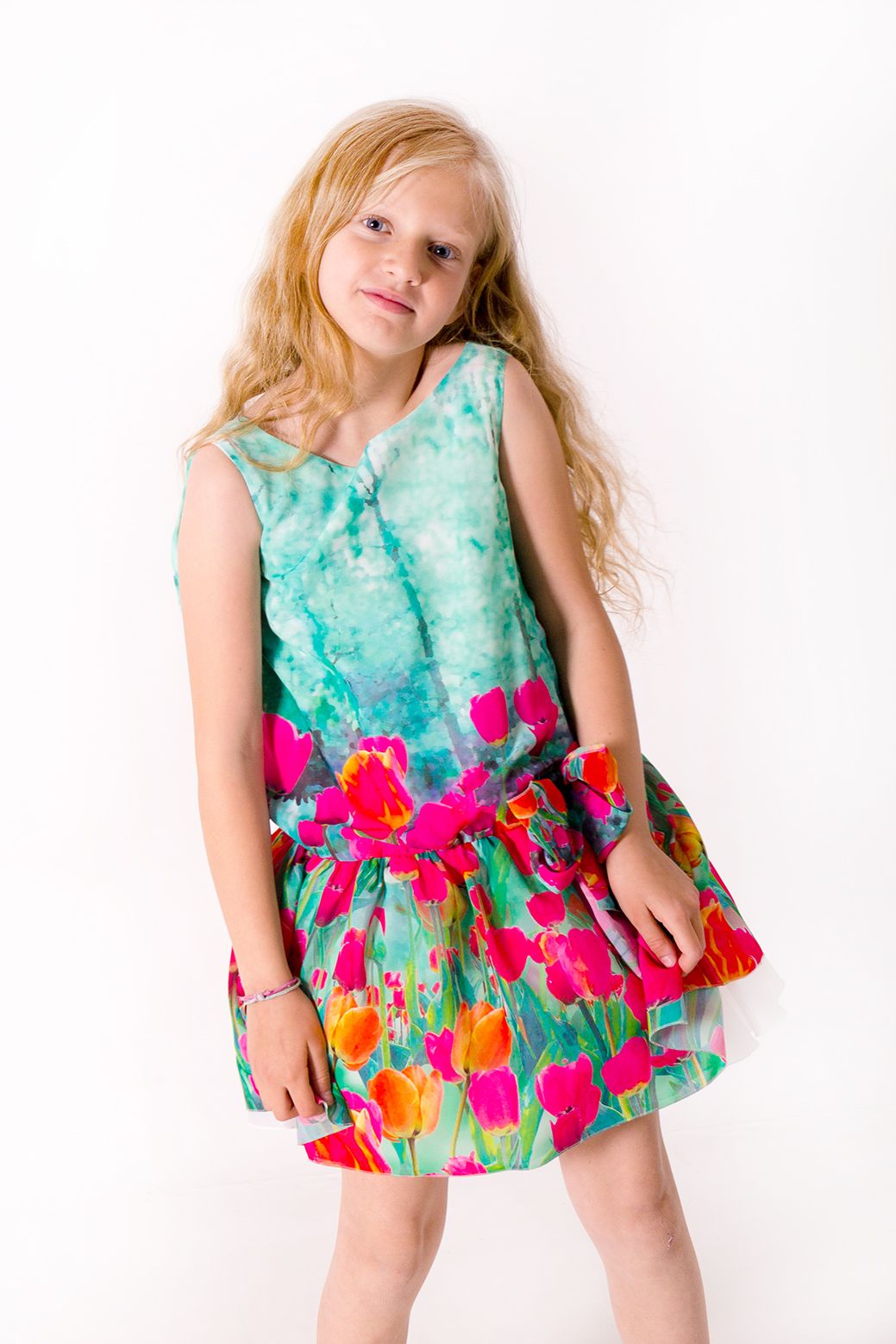 Retrato infantil editorial de moda, niña con vestido de colores en estudio